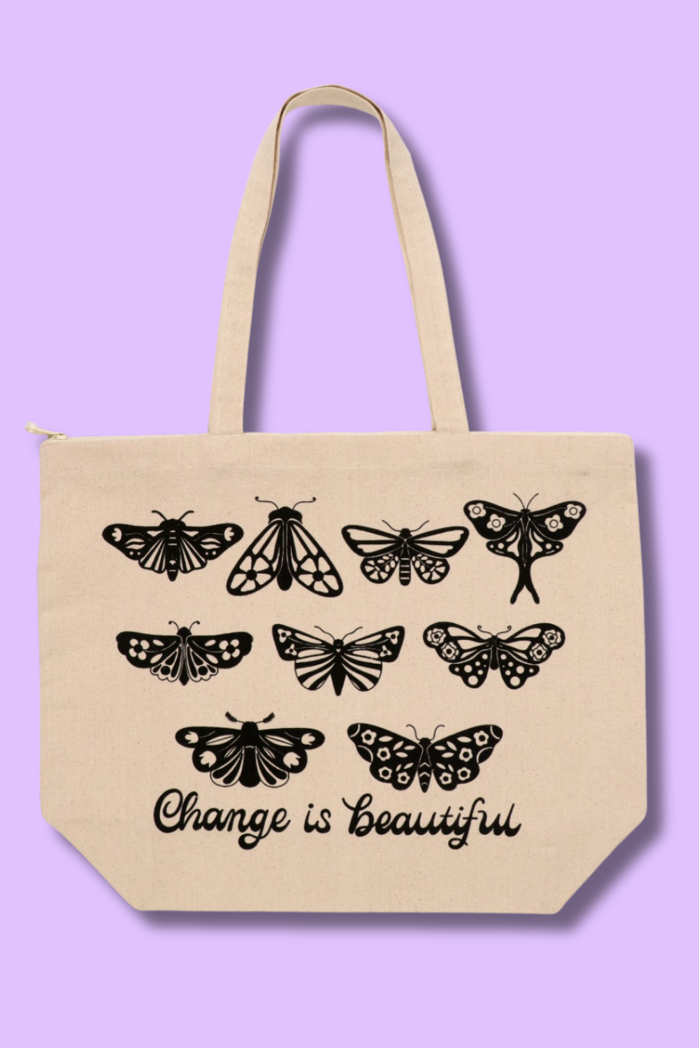 A landscape canvas tote bag with black screen-printed moths and butterflies artwork